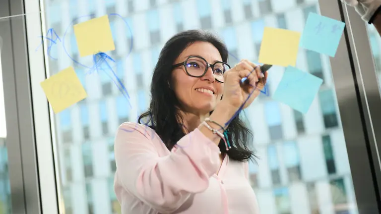 A woman drawing something on a board