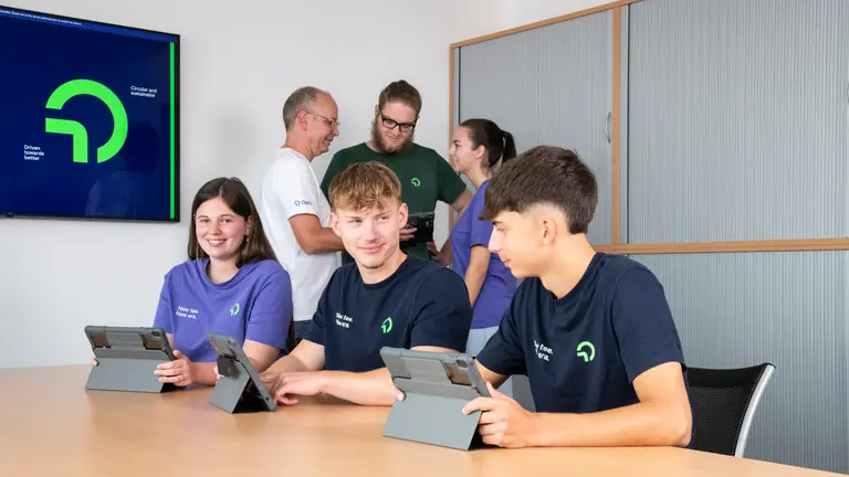 Trainees and workers seated in the OMV office.